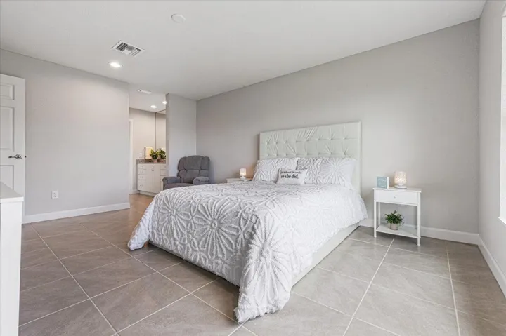 Oversized primary bedroom featuring serene lake views and abundant natural light.