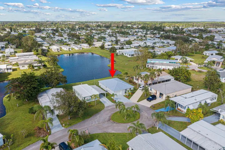 Beautifully maintained CBS home with a metal roof, fresh landscaping, and peaceful lake views.