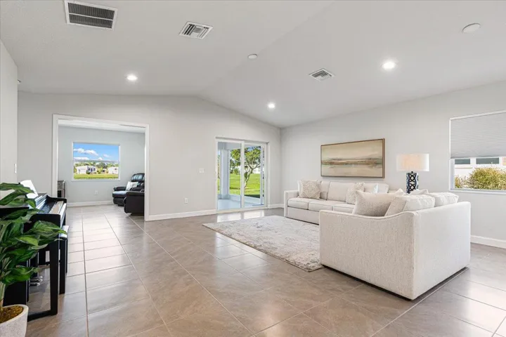 Sliding glass doors frame beautiful lake views and lead to the screened lanai.
