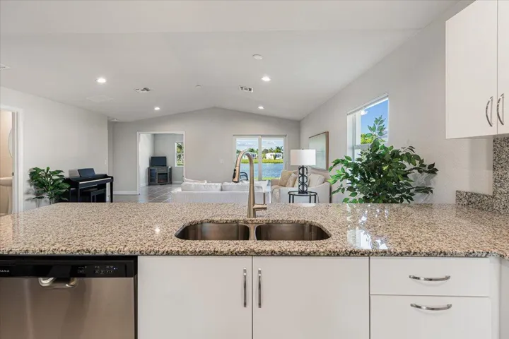 The large breakfast bar keeps you connected to family and guests while enjoying beautiful views of the living area and lake beyond.