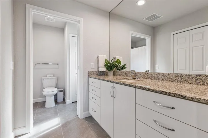 Well-appointed en-suite bath with an oversized vanity, generous storage.