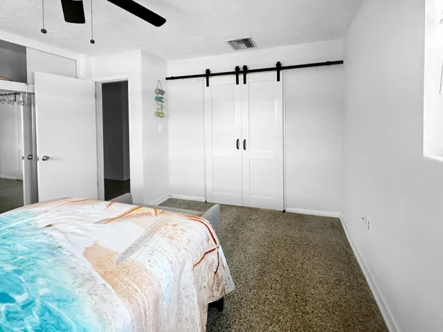 Bedroom with barn doors closing off sitting area/possible additional bedroom