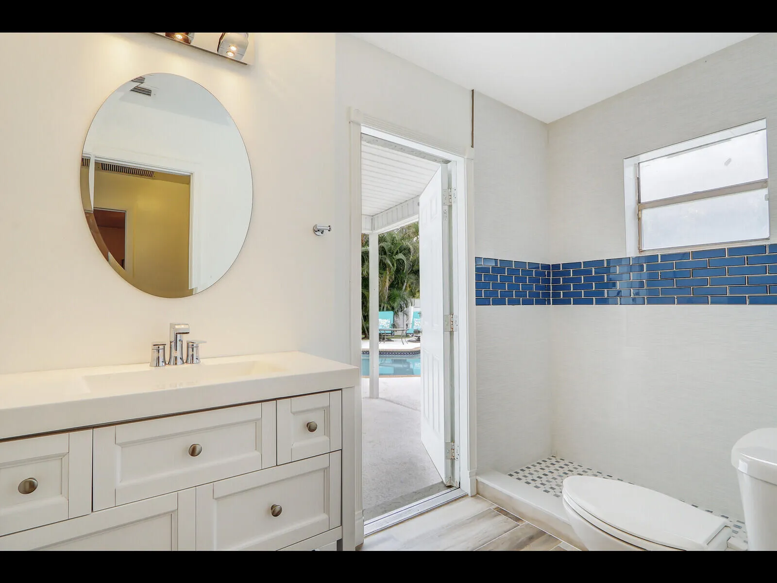 Bathroom with door out to pool area