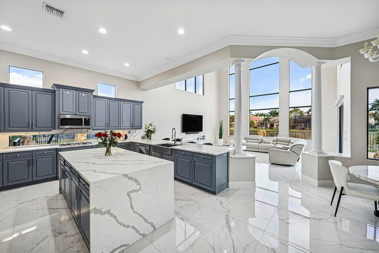 Elegant Chef's Kitchen open to the Family Room. Soaring windows overlook the lake.