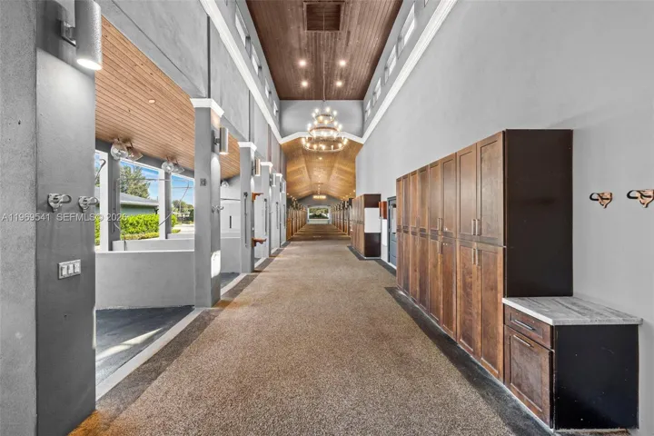 Barn hallway with high tongue & groove ceilings and lockers for supplies.