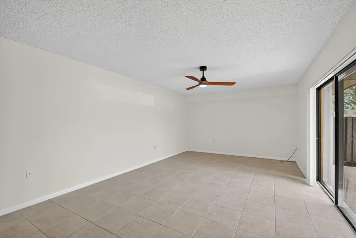 Light and bright living area has sliding glass doors that open to the private and fenced patio