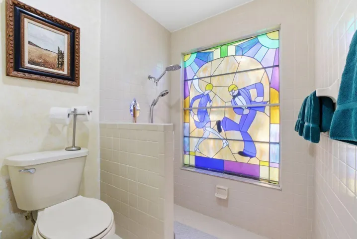 En-suite primary bathroom with step-down shower and inlay windows