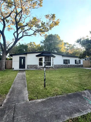 Exterior featuring light-toned siding, a stone veneer base, a multi-pane bay window, and dark-finished shutters