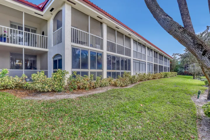 Well-maintained exterior with screened patios and manicured landscaping throughout the community.