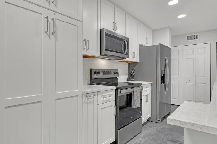 Crisp white cabinetry and ample counter space provide both beauty and function.