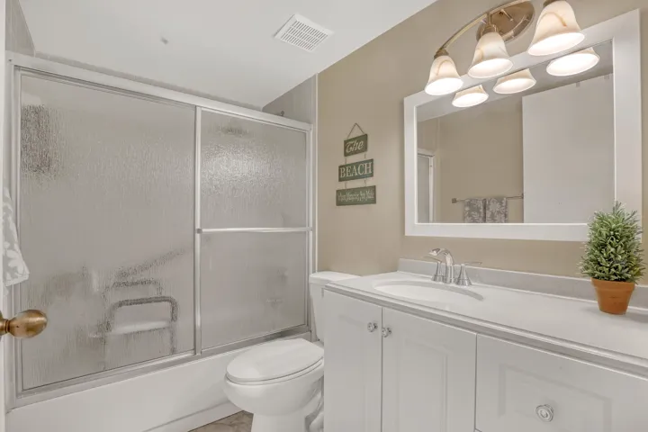 A clean vanity, updated lighting, and tub/shower combination create a welcoming space for visitors.
