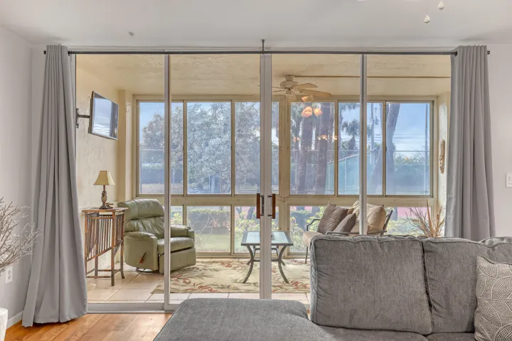 Sliding glass doors extend your living space into the enclosed patio, bringing in light and coastal breezes.