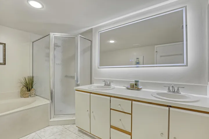 Double sinks and generous counter space offer everyday convenience in this well-designed primary bathroom.