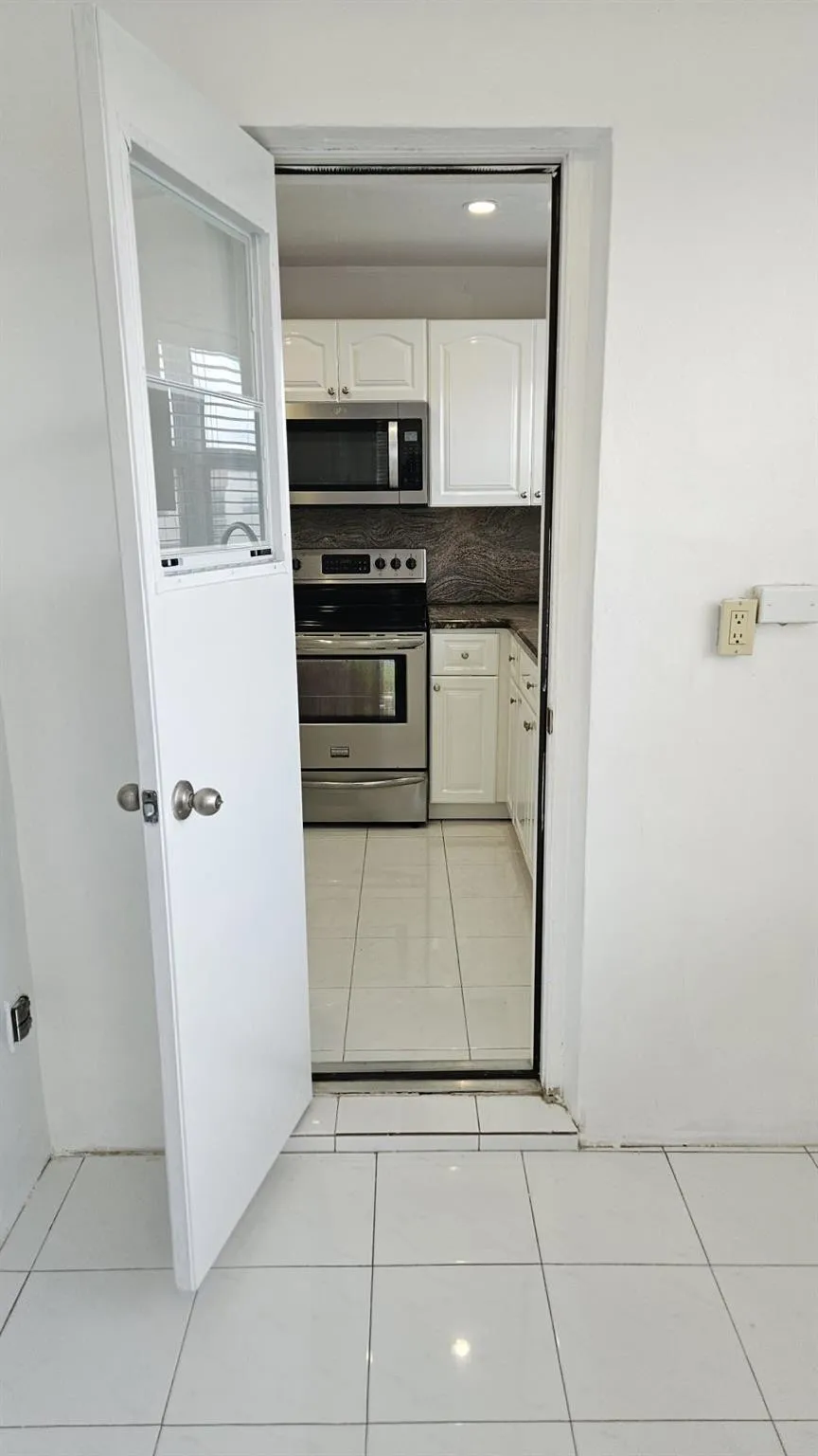 Door from wrap around balcony that leads to kitchen