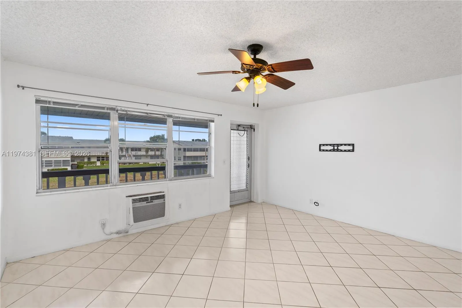 Bright living room with well-maintained AC for added comfort
