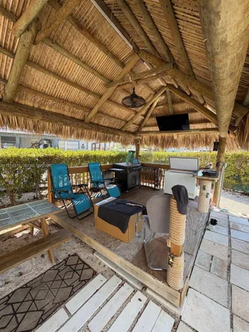 Tiki with BBQ and sitting area for entertainment