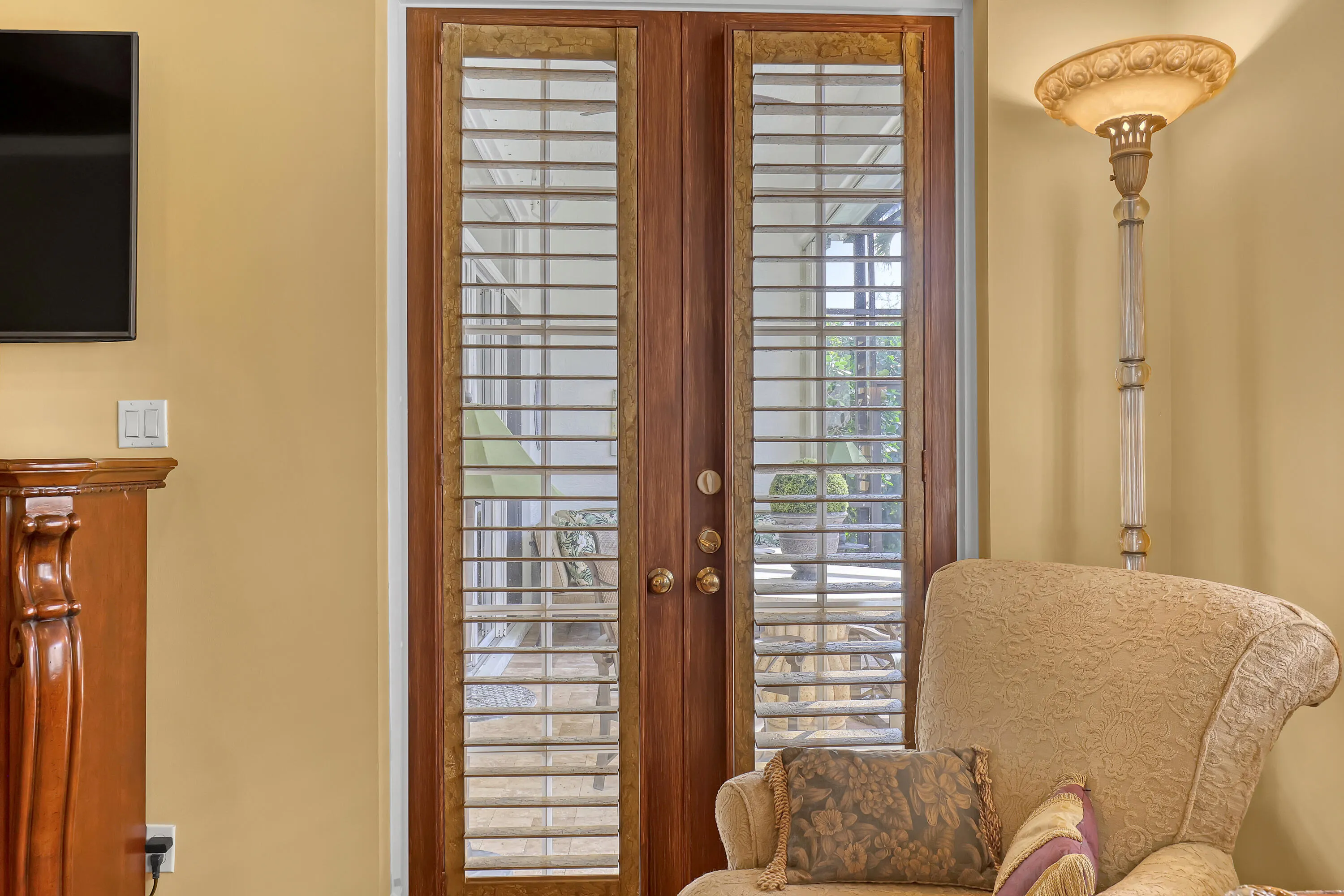 Plantation shutters on French doors for filtered light or deep sleep