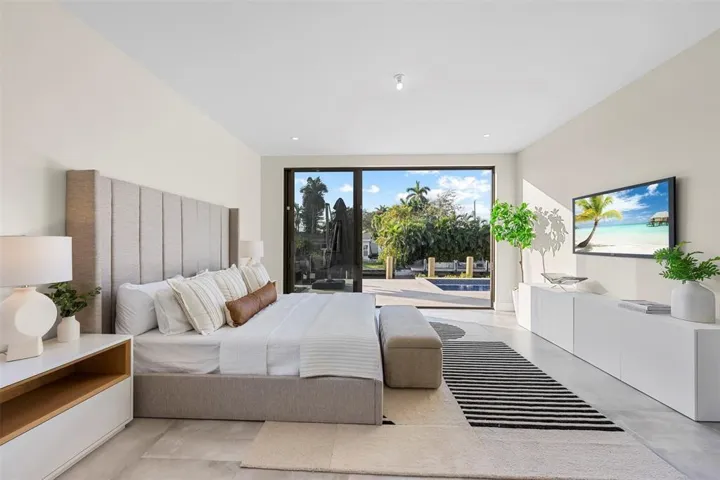 Expansive glass sliding doors, recessed lighting, and a linear built-in media console