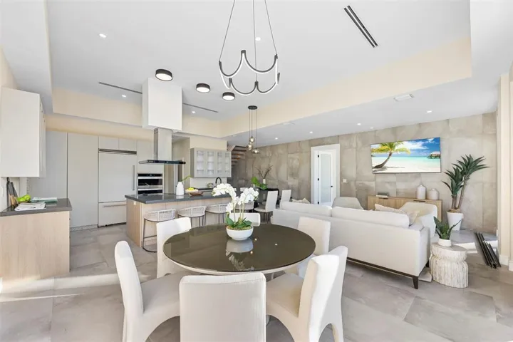 Open-concept living area with tile flooring and a textured accent wall