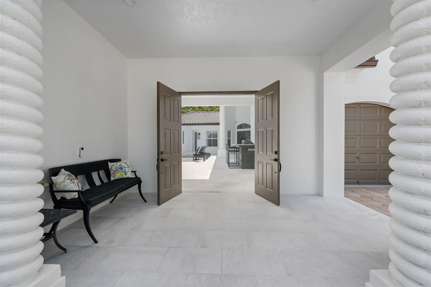 Tumbled marble pavers from front entry throughout courtyard.