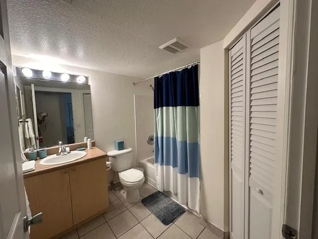 guest bathroom with tub and linen closet