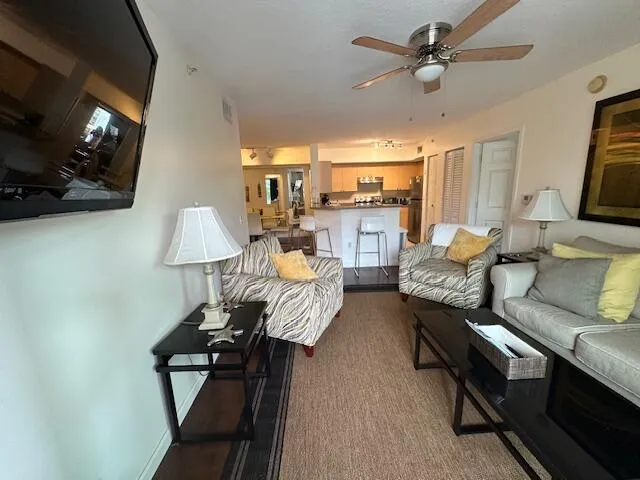 living room with pull out couch large TV and patio through impact sliding doors