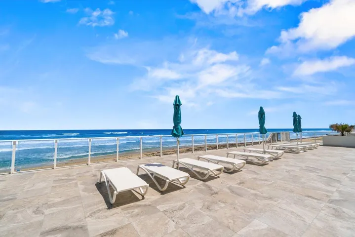 Lots of Lounge Chairs on the Pool DeckOverlooking the Ocean