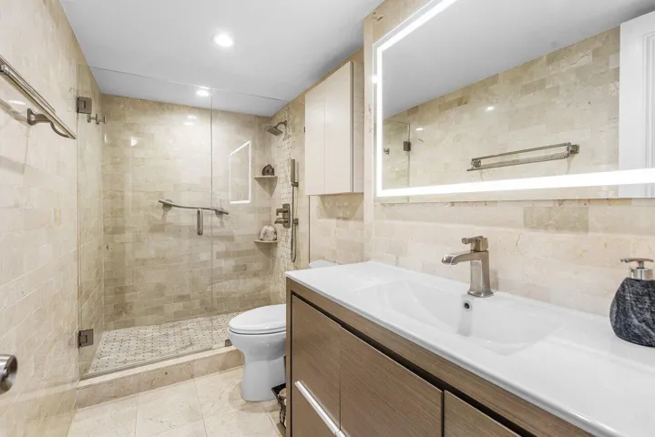 Second Full Bathroom with with Marble Floors, Shower and Walls, also has a Light Up Mirror and Toto Toilet.