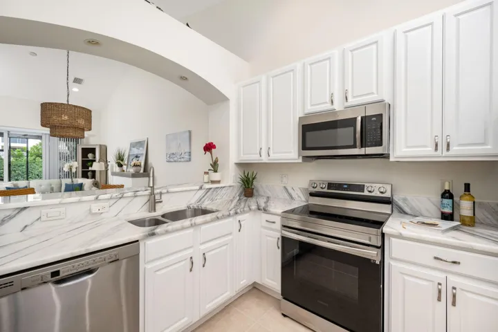 Freshly painted cabinets, granite counters and pantry closet