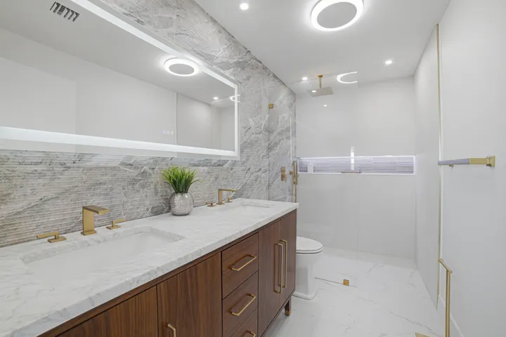 The main bathroom is spacious, modern, and features excellent lighting and a stylish color palette.