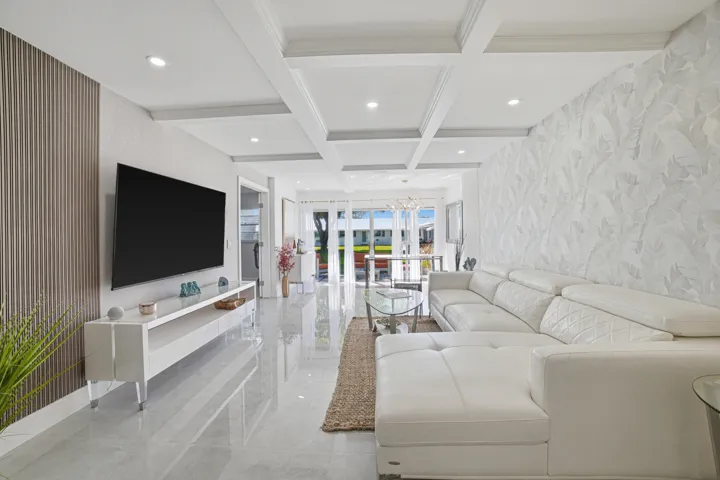 A large TV is shown- wall mounted above a suspended media console. Here Style, and Space Saving go hand in hand