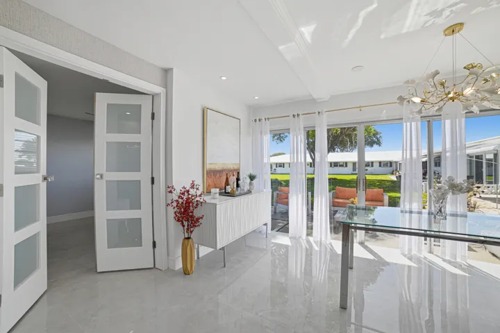 Spacious and bright dining area with view of patio and garden.