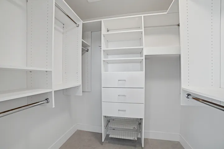 The primary bedroom includes a walk-in closet with built-in organizer, offering efficient storage and organization for personal belongings.