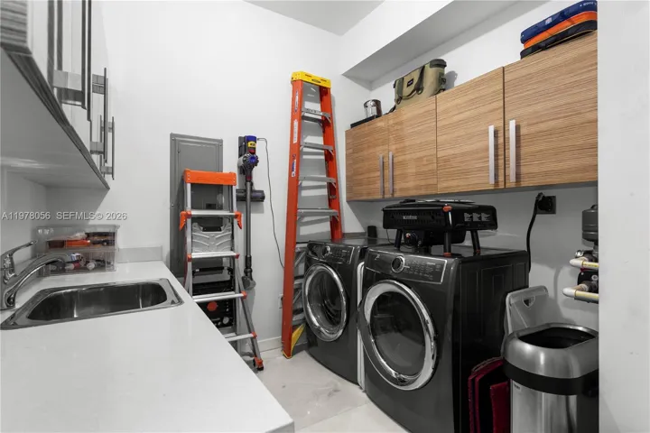 Spacious laundry room with storage, washer and dryer