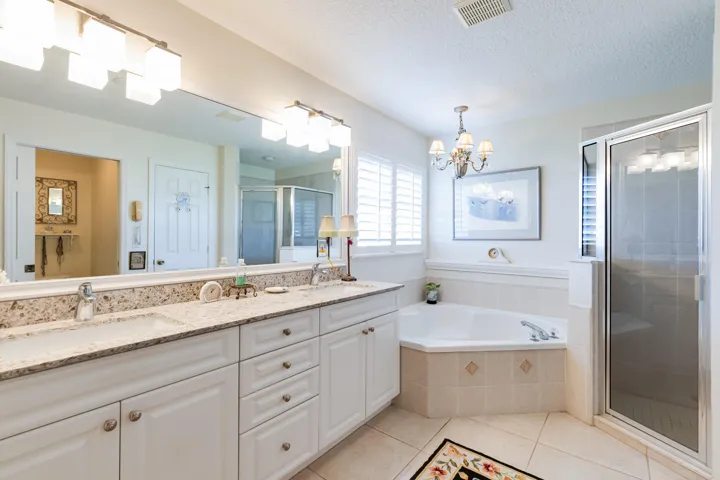 Bathroom with Dual Sinks, Tub and Walk-In Shower. Granite Countertops. Linen Closet.
