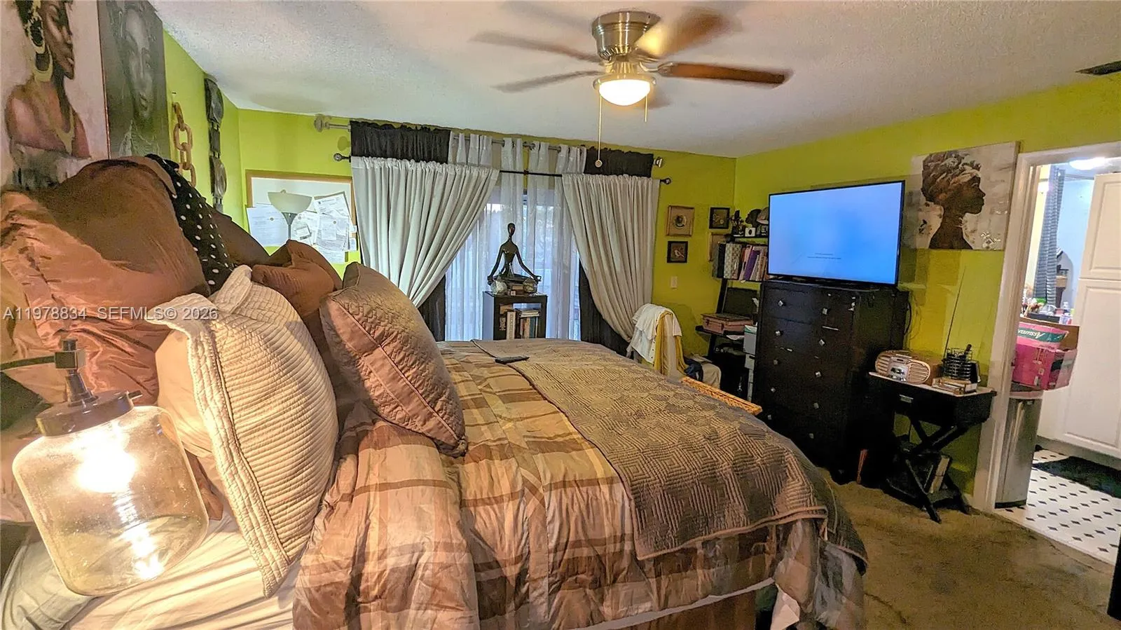 Primary bedroom with direct access to the balcony, private bathroom, and a walk-in closet