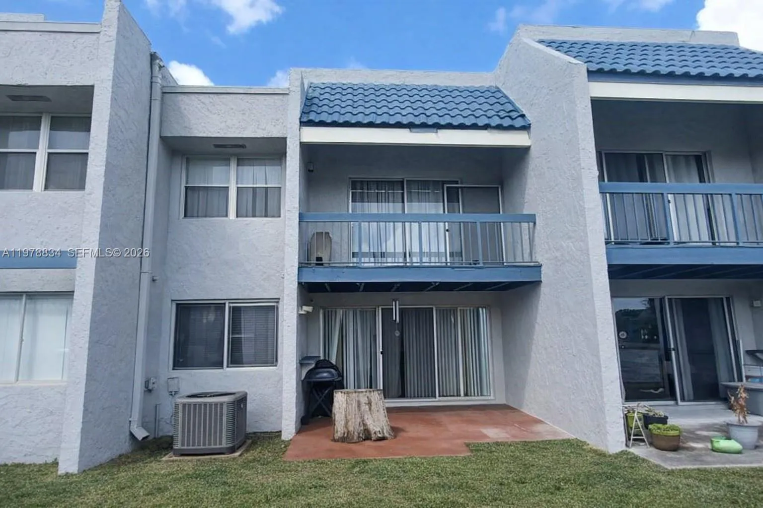 Rear view of the townhouse with open green space and lake views