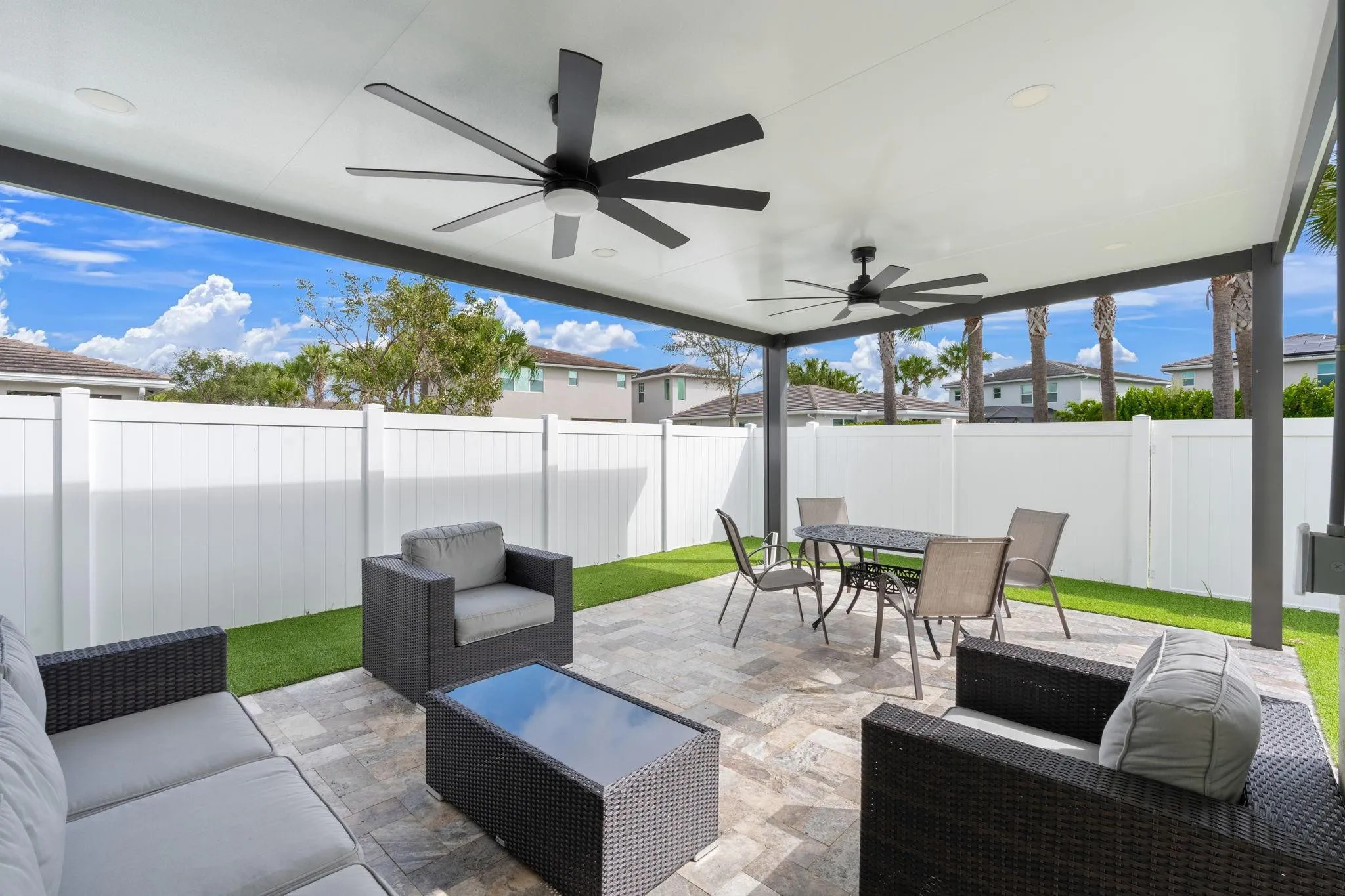 Stay Cool in Your Shaded Backyard with 2 Oversized Fans and Modern Travertine Tile. Pergola area has connections for Water and Electricity. Put your fine touch on this home with a Summer Kitchen.