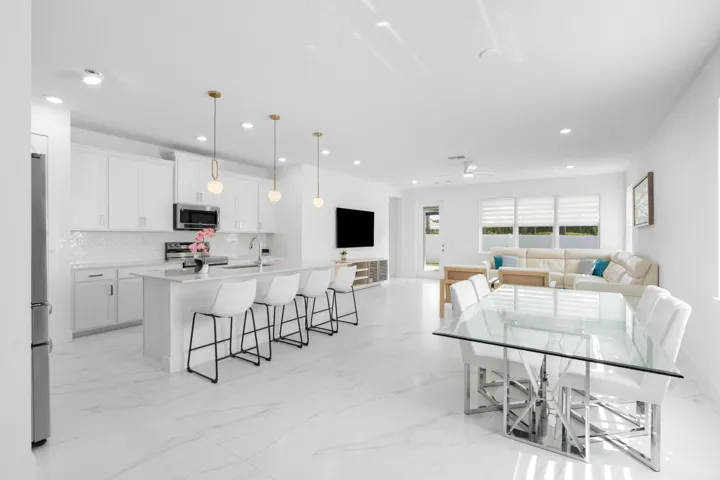 Step into a beautifully updated Living Room, Dining Room and Living Room complete with Modern Lighting and Dual Roller Shades and Porcelain Tile Throughout the First Floor. No Carpet in the home.