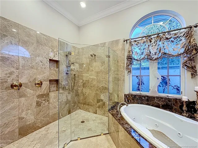 This bathroom is so large it is hard to get one full photo. Jacuzzi jet tub and oversized shower with seamless glass. 2 sinks spit acroos from each other , Water closet with a door has a toilet and a seperate bidet.