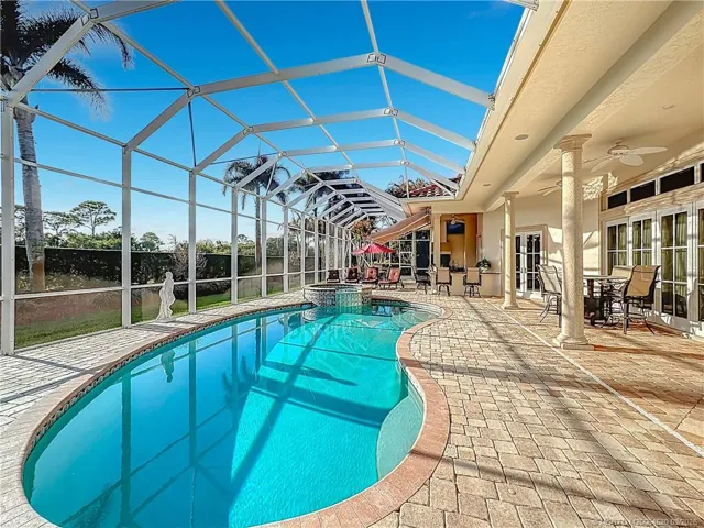 Let's take a splash in the hot tub and heated pool area. Relax with a beverage in your bar are and summer kitchen