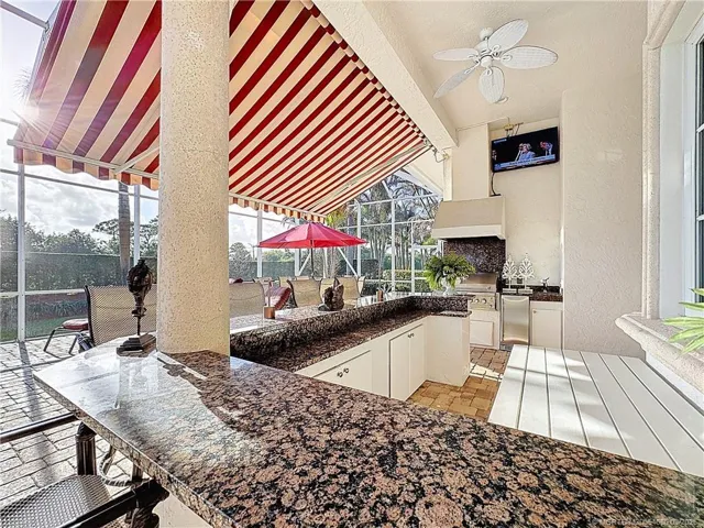Large bar AND SUMMER KITCHEN, TV, LITTLE REFRIGERATOR SINK AND WATER. walk INTO THE kitchen THROUGH THE FRENCH DOOR AND CABANA BATH OFF THE PATIO. ENJOY TH 9TH FAIRWAY. With a retractable canopy.