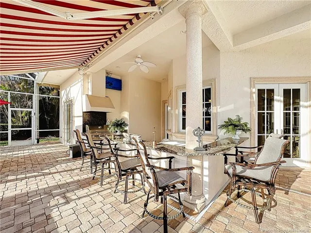 summer kitchen, bar area refrigerator, sink and flat screen TV, paver patio. The canopy is retractable.
