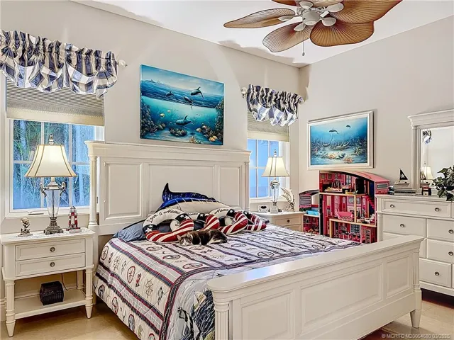 THIS IS THE BEDROOM ATTACHED TO THE BATHROOM AS An EN-SUITE. THE FLOORS ARE TRAVERTINR TILEIN BEDROOMS. MARBLE IN THE MAIN FLOORS OF THE HOME. FAN. FRENCH DOOR OUT TO THE POOL AREA AND PATIO OUT IN THE HALLWAY. SO CONVENIENT TO EVERYTHING TO EVERYTHING IN THE HOME.