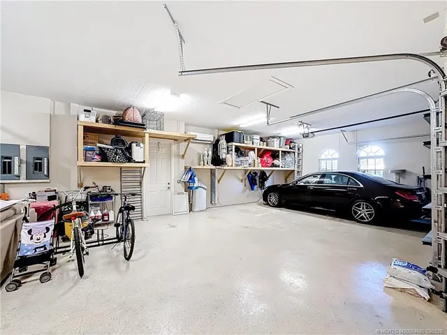 OVERSIZED 3 CAR GARAGE WITH A GOLF CART GARAGE SIDE DOOR TO GET OUT, PULL DOWN STEPS. ALL DOORS HAVE OPENERS. CENTRAL VACUUM. 2 eLECTRIC BOXES.