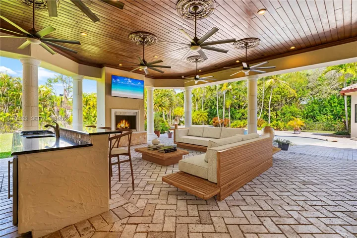 Oversized patio off the family room with outdoor kitchen, fire pit, and large TV-perfect for entertaining and enjoying a game
