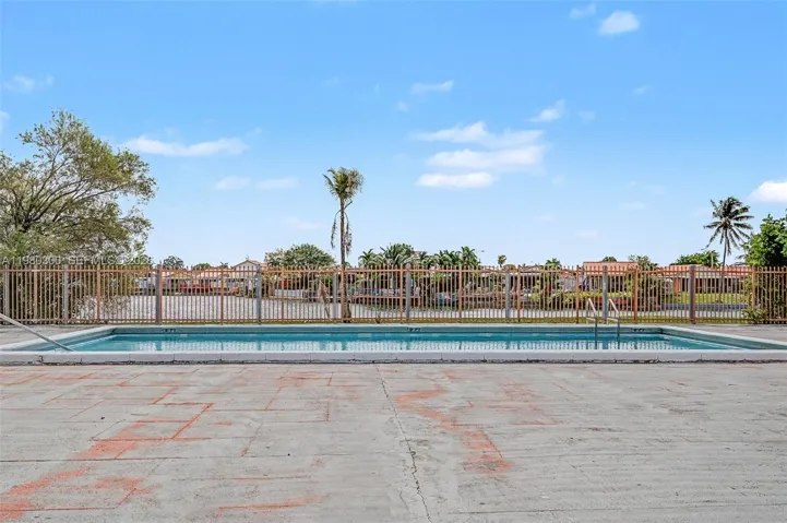 One of the Community Pools, steps from property