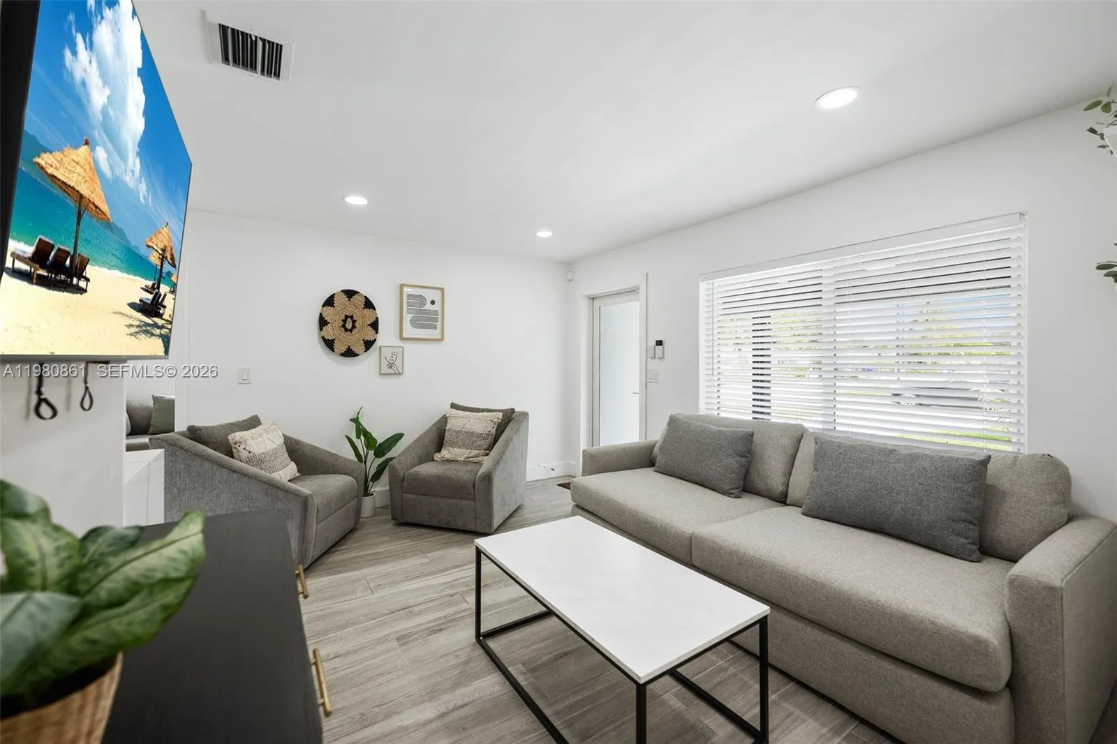 Elegant, light-filled living room featuring refined contemporary furnishings, wide-plank flooring, and seamless flow—an inviting space designed for sophisticated relaxation and effortless entertaining.