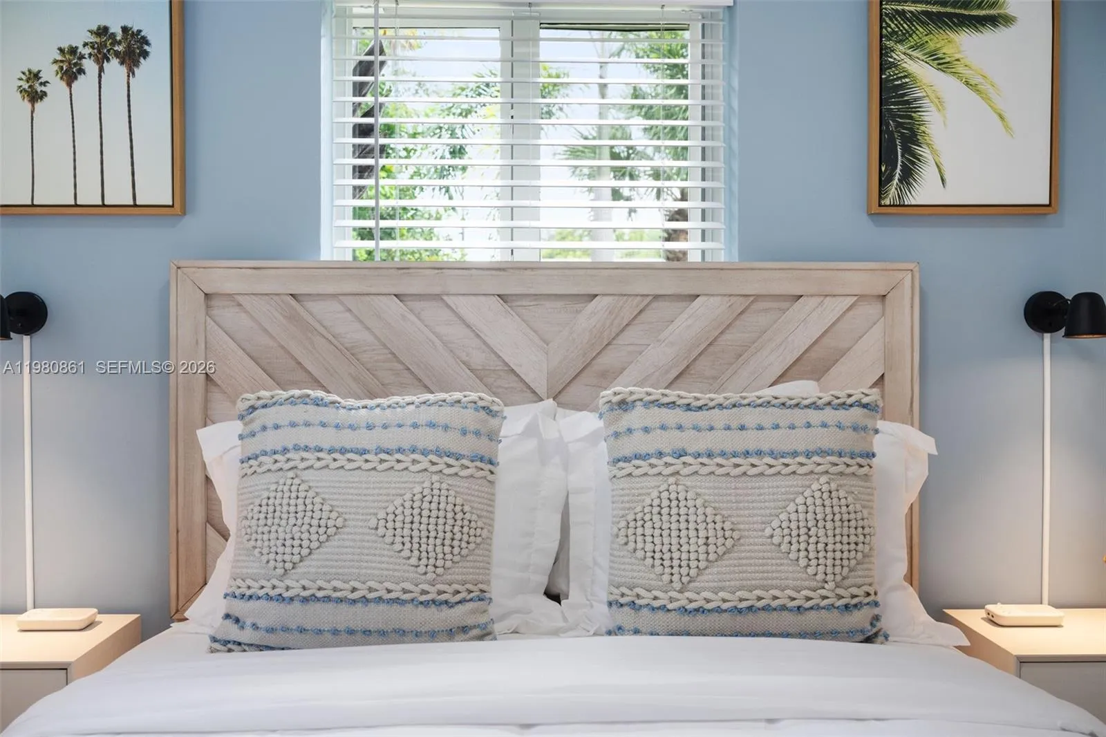 #3. Beautifully styled bedroom retreat featuring a custom wood headboard, soft coastal tones, and curated designer accents—creating a light, tranquil space designed for refined comfort and elevated living.