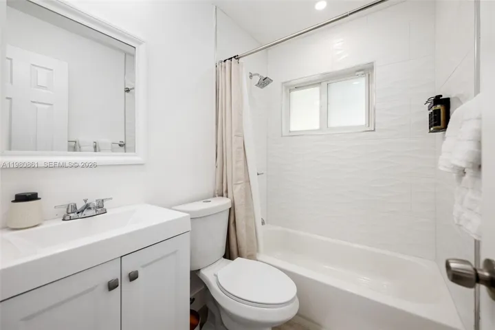 to bedrooms and common area with spa-inspired crisp white finishes, elegant tilework, and a light-filled shower—designed to deliver a serene experience with timeless sophistication.